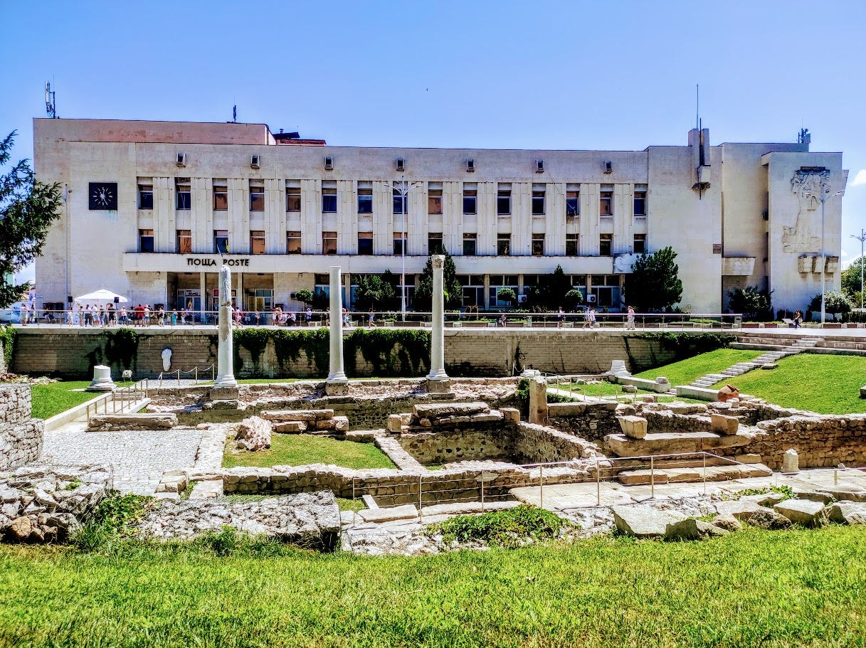 View of Plovdiv's post office behind some Roman ruins.