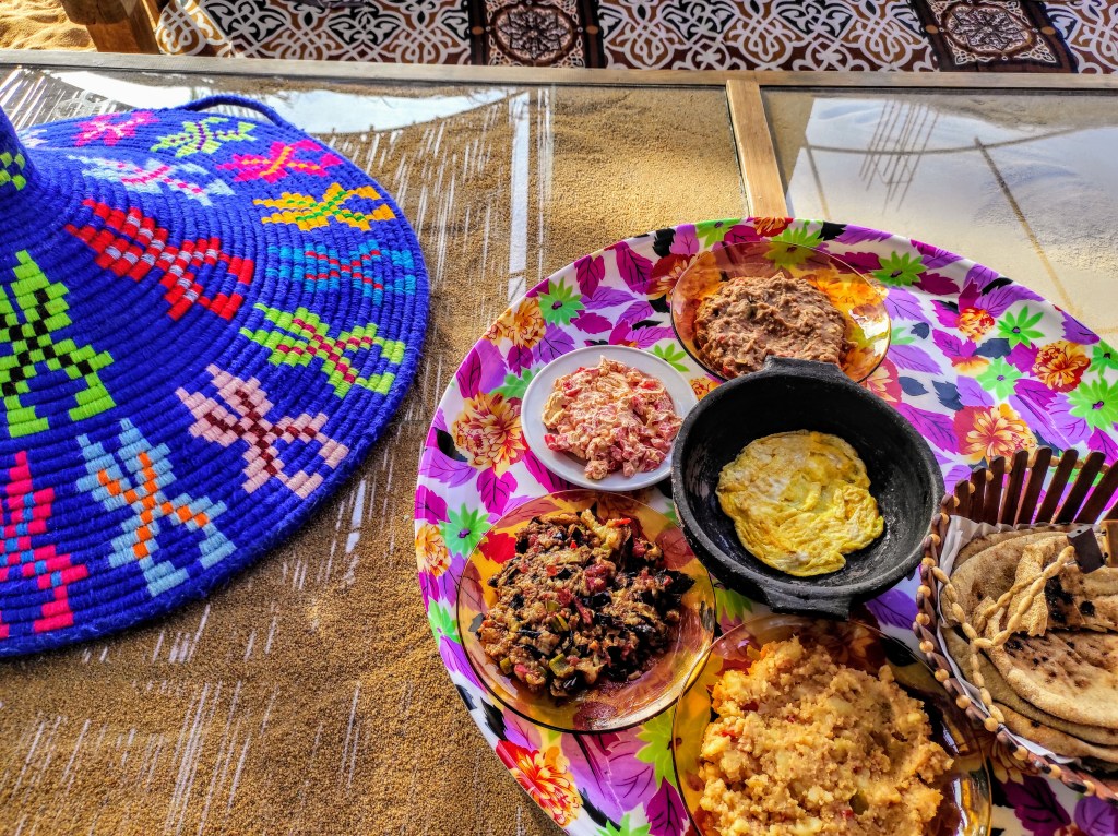A tray of vegetarian dishes with breads 