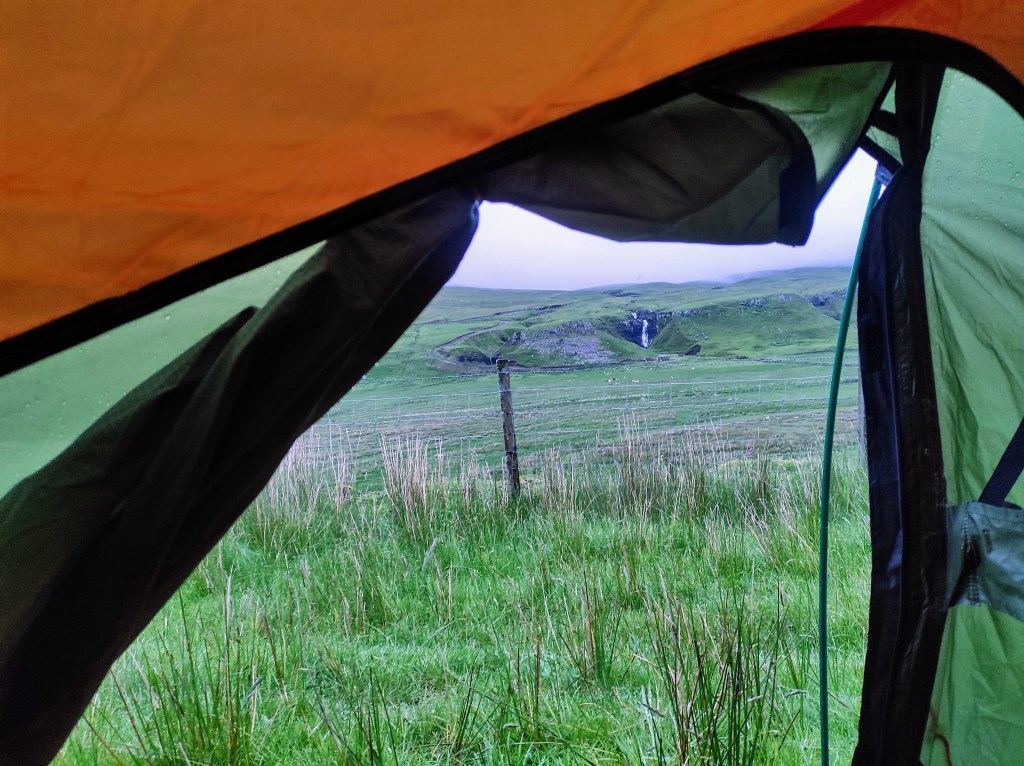 Tent door opens onto Scottish landscape 